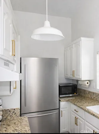 a white refrigerator freezer sitting inside of a kitchen