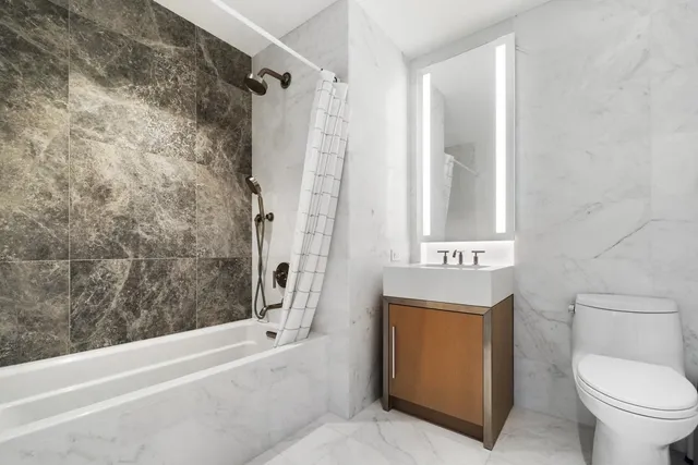 a bathroom with a sink a toilet and a bathtub