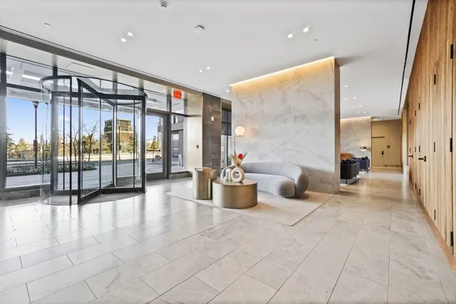 a lobby with furniture and floor to ceiling window