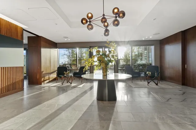 a lobby with furniture and floor to ceiling window