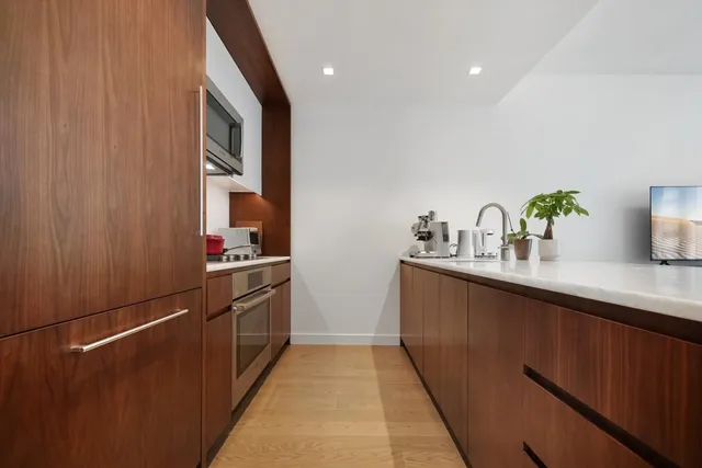 a kitchen with granite countertop a sink and cabinets