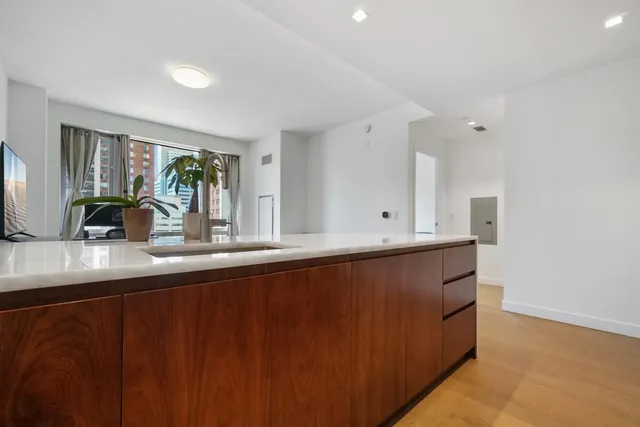 a kitchen with granite countertop a sink a stove and cabinets
