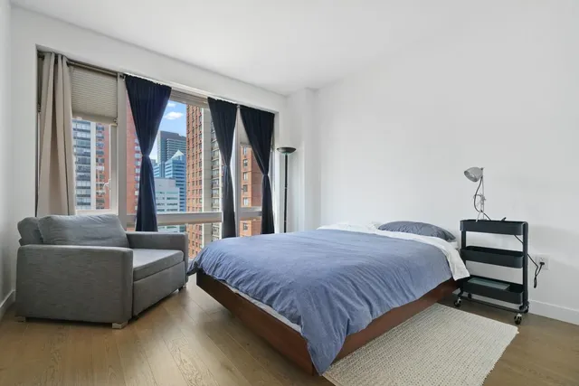 a bedroom with a bed and a couch