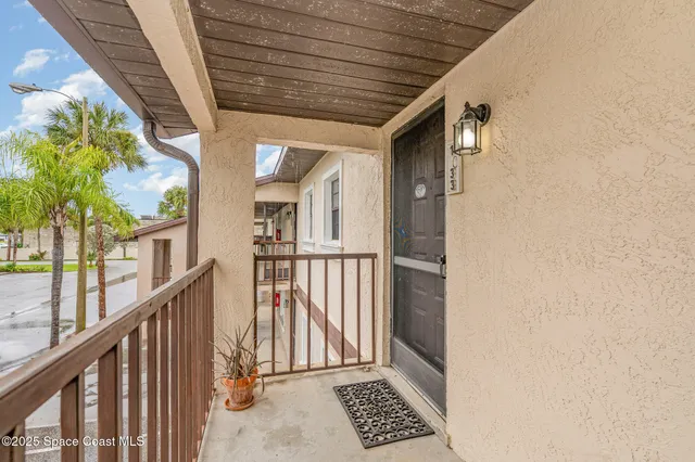 a view of balcony with wooden floor