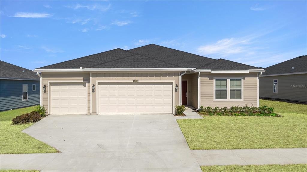 6896 Southwest 87th Street Ocala, FL 34476 - Photo 3 of 5 a front view of a house with a yard