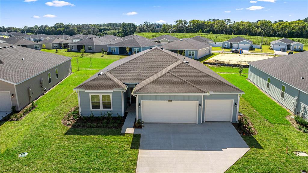 6896 Southwest 87th Street Ocala, FL 34476 - Photo 5 of 5 an aerial view of a house with garden space and lake view