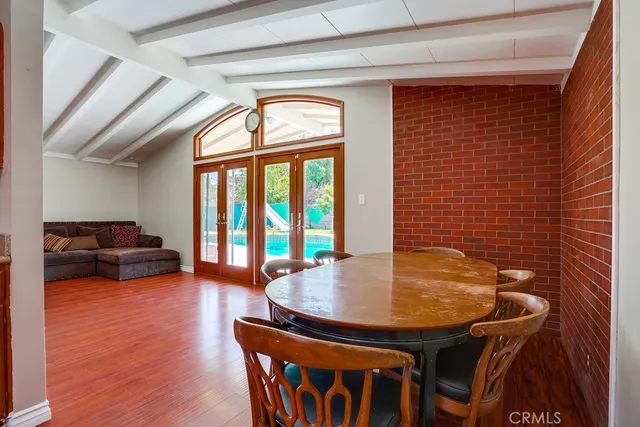 a dining room with furniture and wooden floor