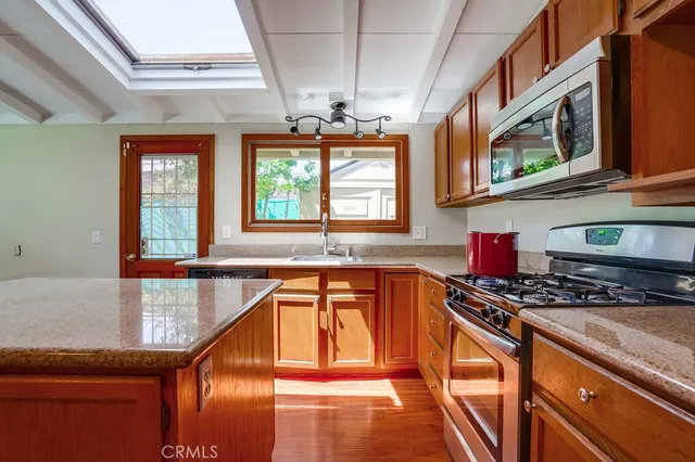 a kitchen with stainless steel appliances granite countertop a stove and a sink