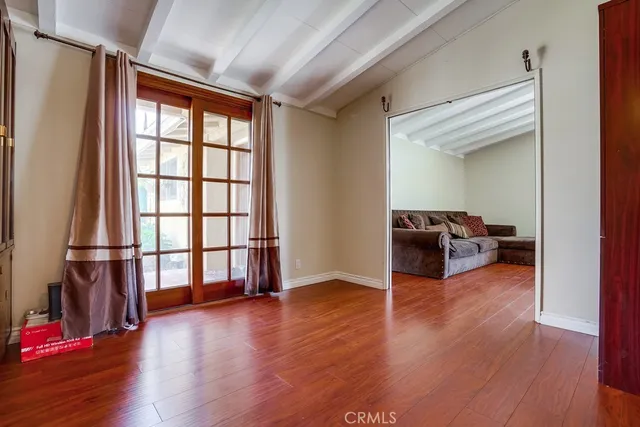 a living room with furniture or wooden floor and a large window