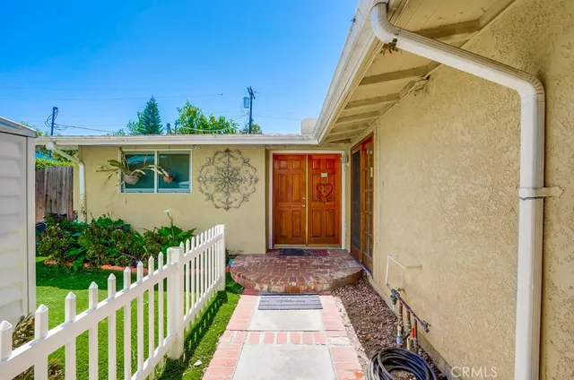 a view of a house with wooden fence