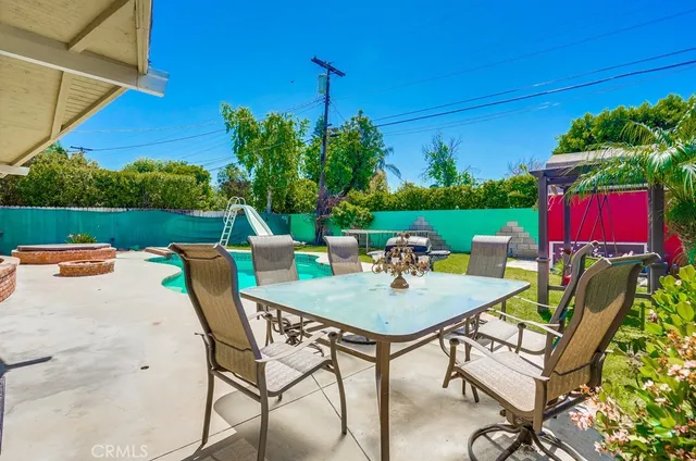 a front view of house with swing and slide