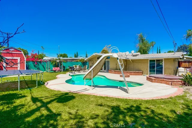 a view of house with swimming pool outdoor seating