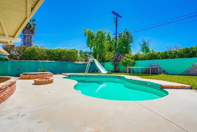 a view of a swimming pool with a yard