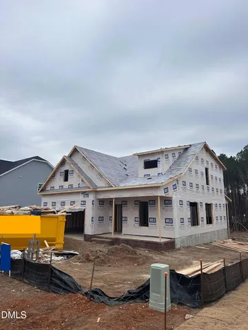 a view of a house with pool and sitting area