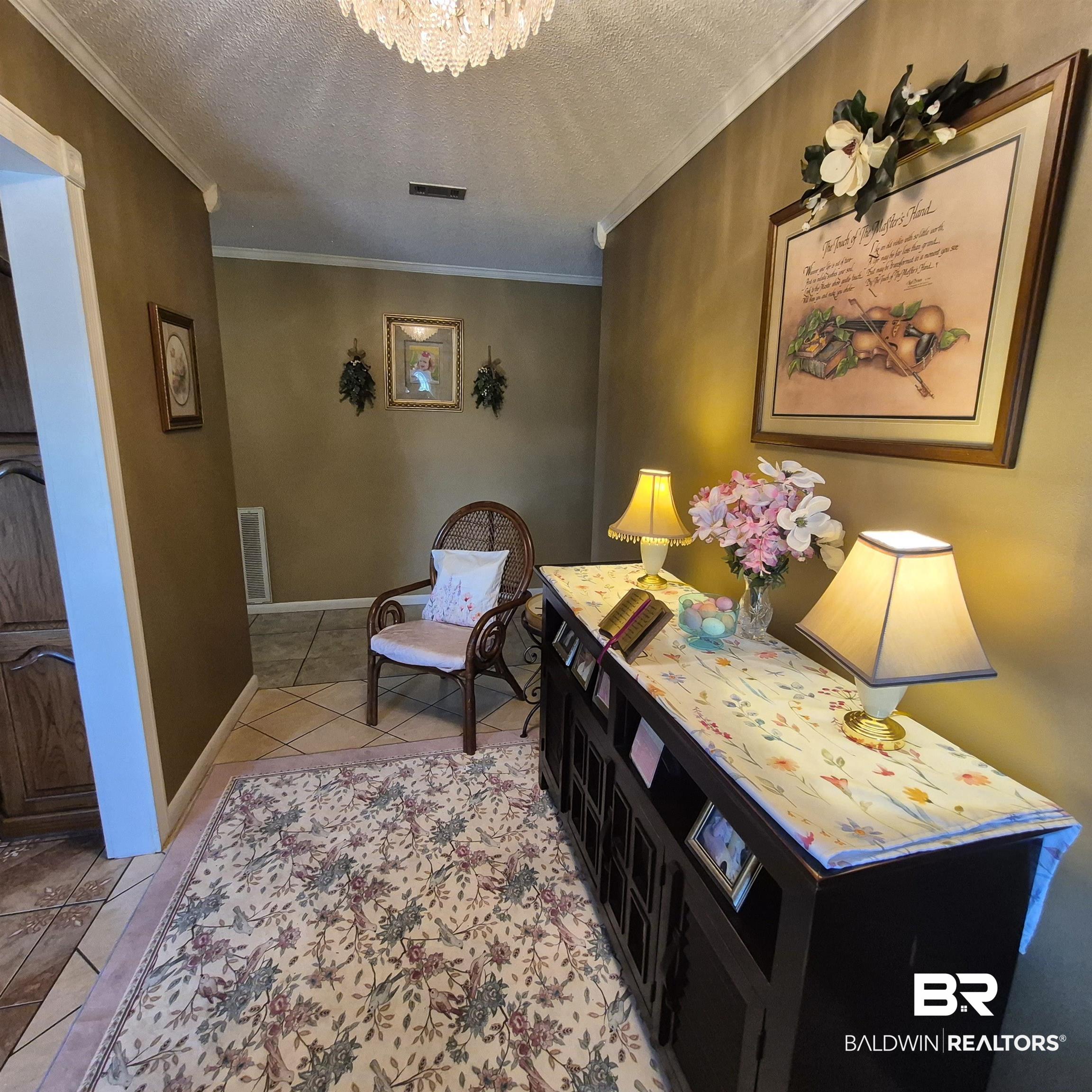 26635 Highway 41 Range, AL 36473 - Photo 22 of 74 Bedroom featuring a textured ceiling, light tile patterned floors, ornamental molding, and suspended lighting