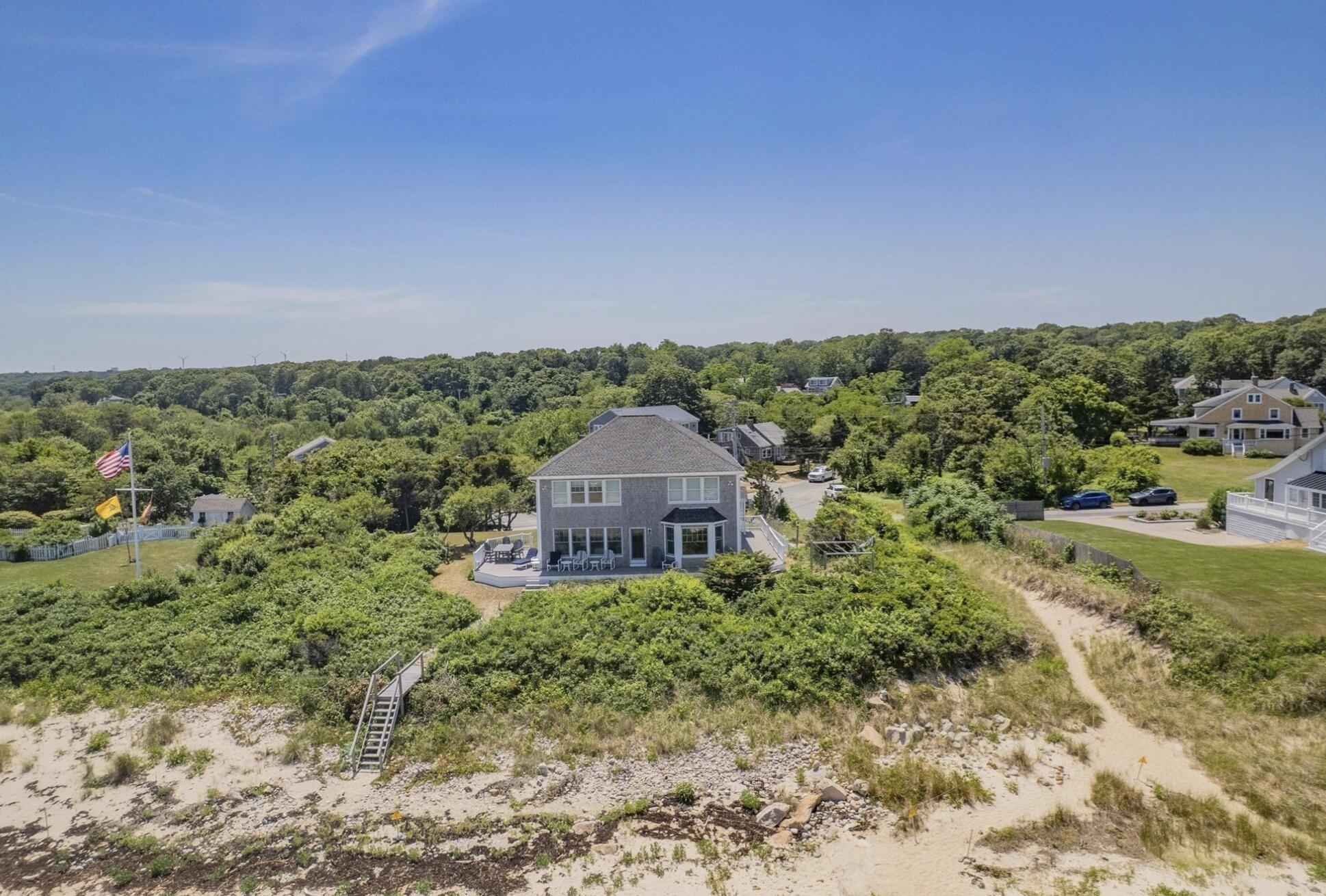 67 Phillips Road Sagamore Beach, MA 02562 - Photo 30 of 34 a view of a large garden with large trees and plants in front of it