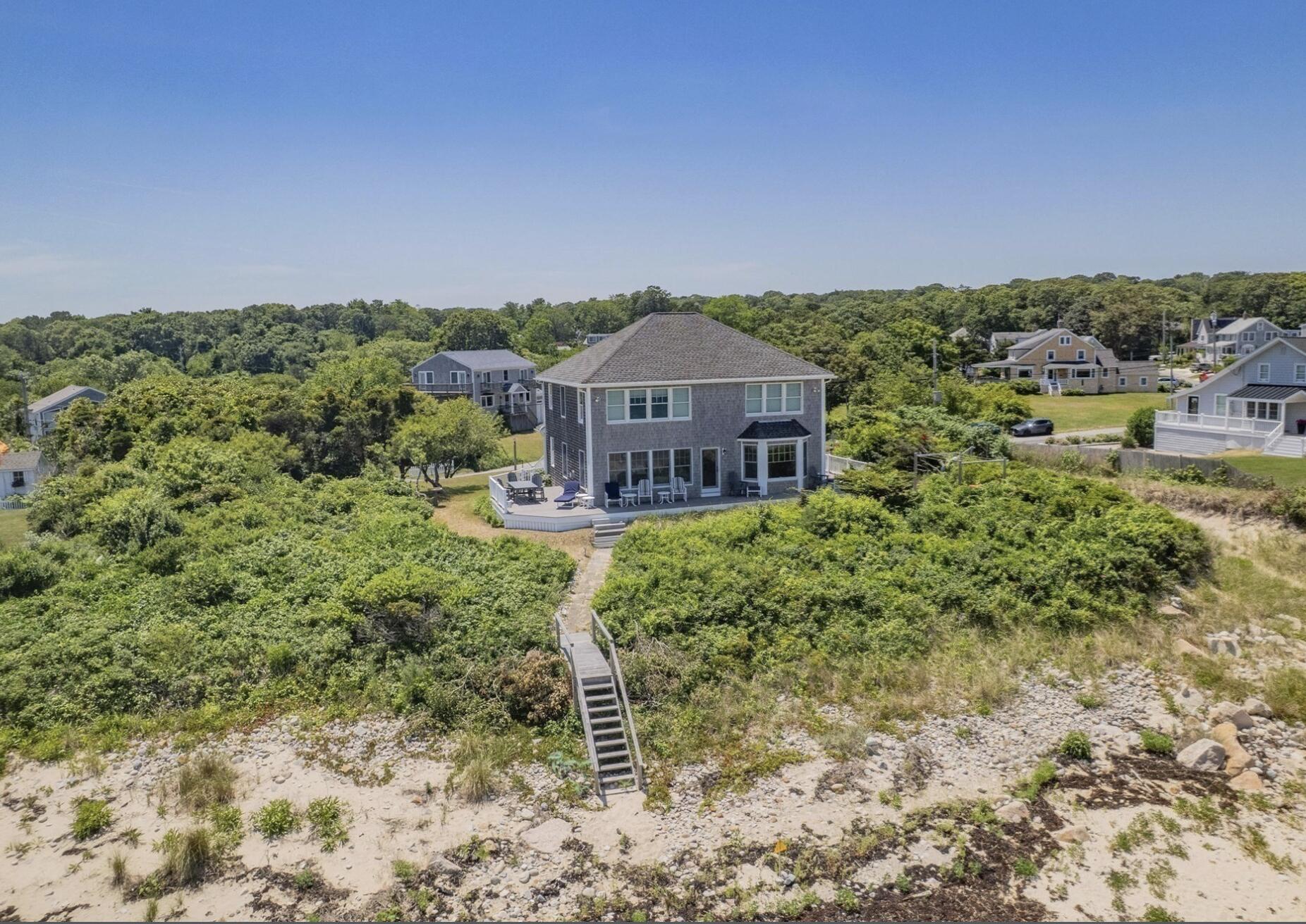 67 Phillips Road Sagamore Beach, MA 02562 - Photo 31 of 34 a backyard of a house with a garden and deck