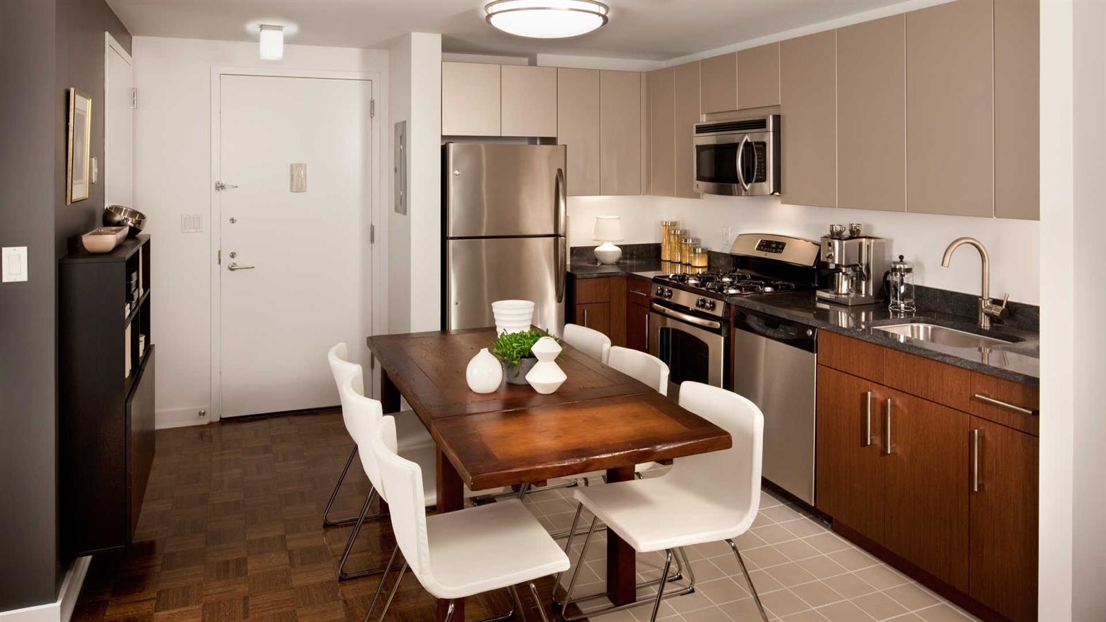 111 Lawrence Street, Unit 31J Brooklyn, NY 11201 - Photo 10 of 10 a kitchen with stainless steel appliances a refrigerator a stove a sink a dining table and chairs