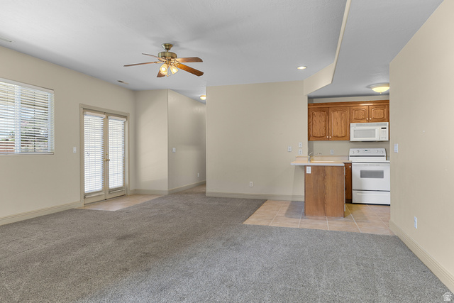 389 North Main Street St. George, UT 84770 - Photo 44 of 44 Kitchen featuring light countertops, open floor plan, white appliances, light colored carpet, and ceiling fan