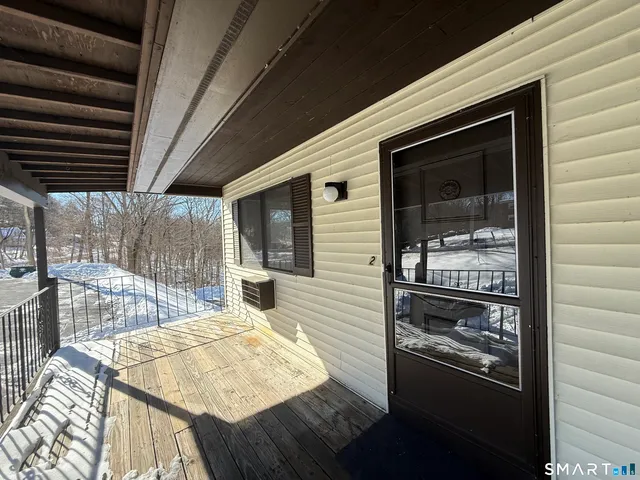 a balcony with table and chairs