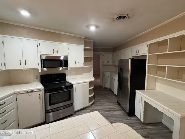 a kitchen with a sink appliances and cabinets