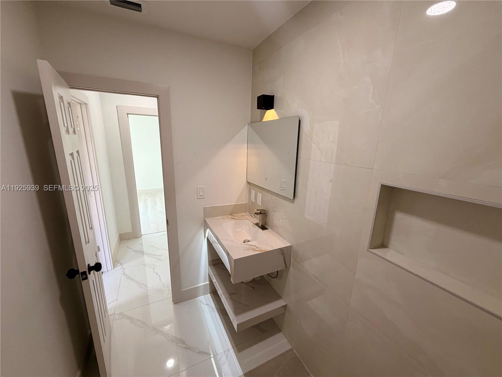 3527 Northwest 17th Street Miami, FL 33125 - Photo 11 of 18 a bathroom with a sink toilet and shower