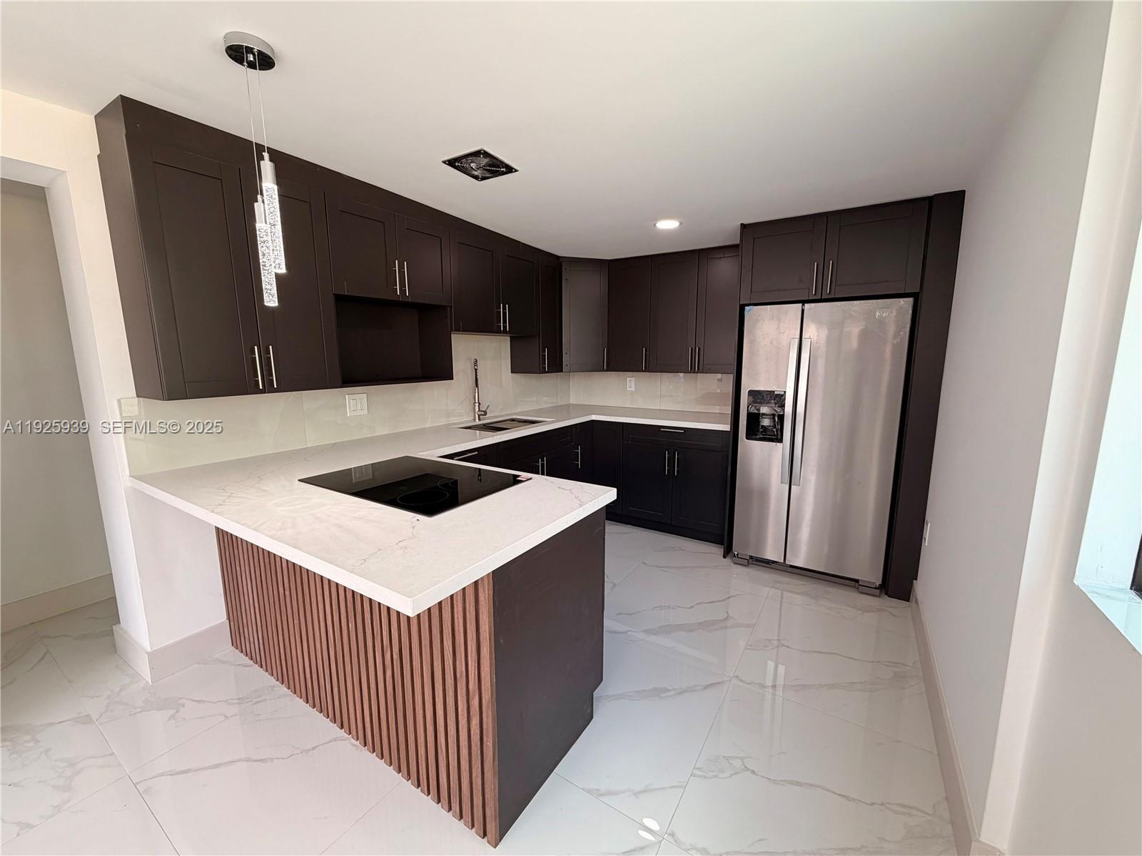 3527 Northwest 17th Street Miami, FL 33125 - Photo 3 of 18 a kitchen with stainless steel appliances a refrigerator and a stove