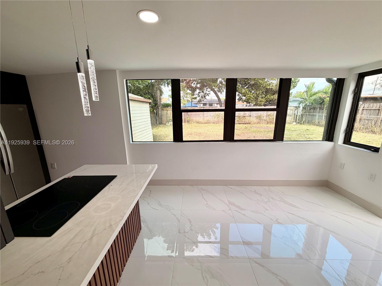 3527 Northwest 17th Street Miami, FL 33125 - Photo 4 of 16 a spacious bedroom with a large bed and a large window