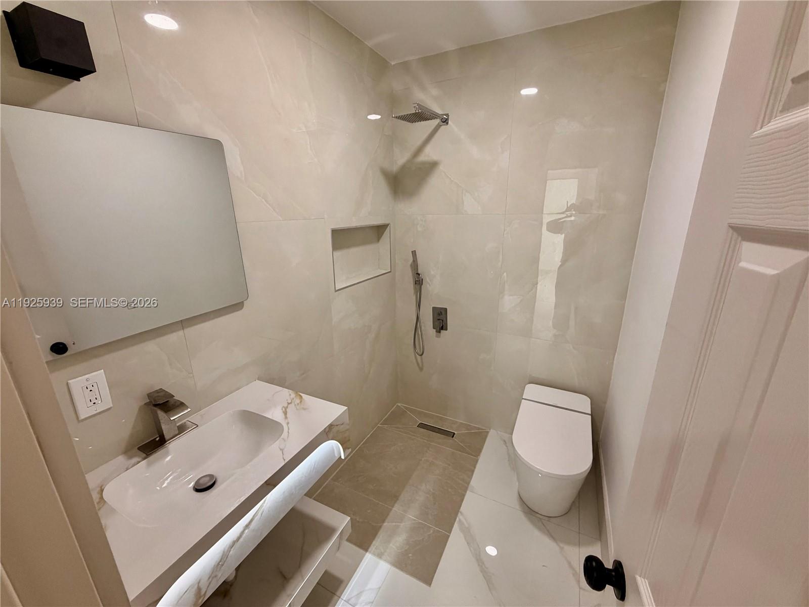 3527 Northwest 17th Street Miami, FL 33125 - Photo 8 of 16 a bathroom with a sink a toilet and shower