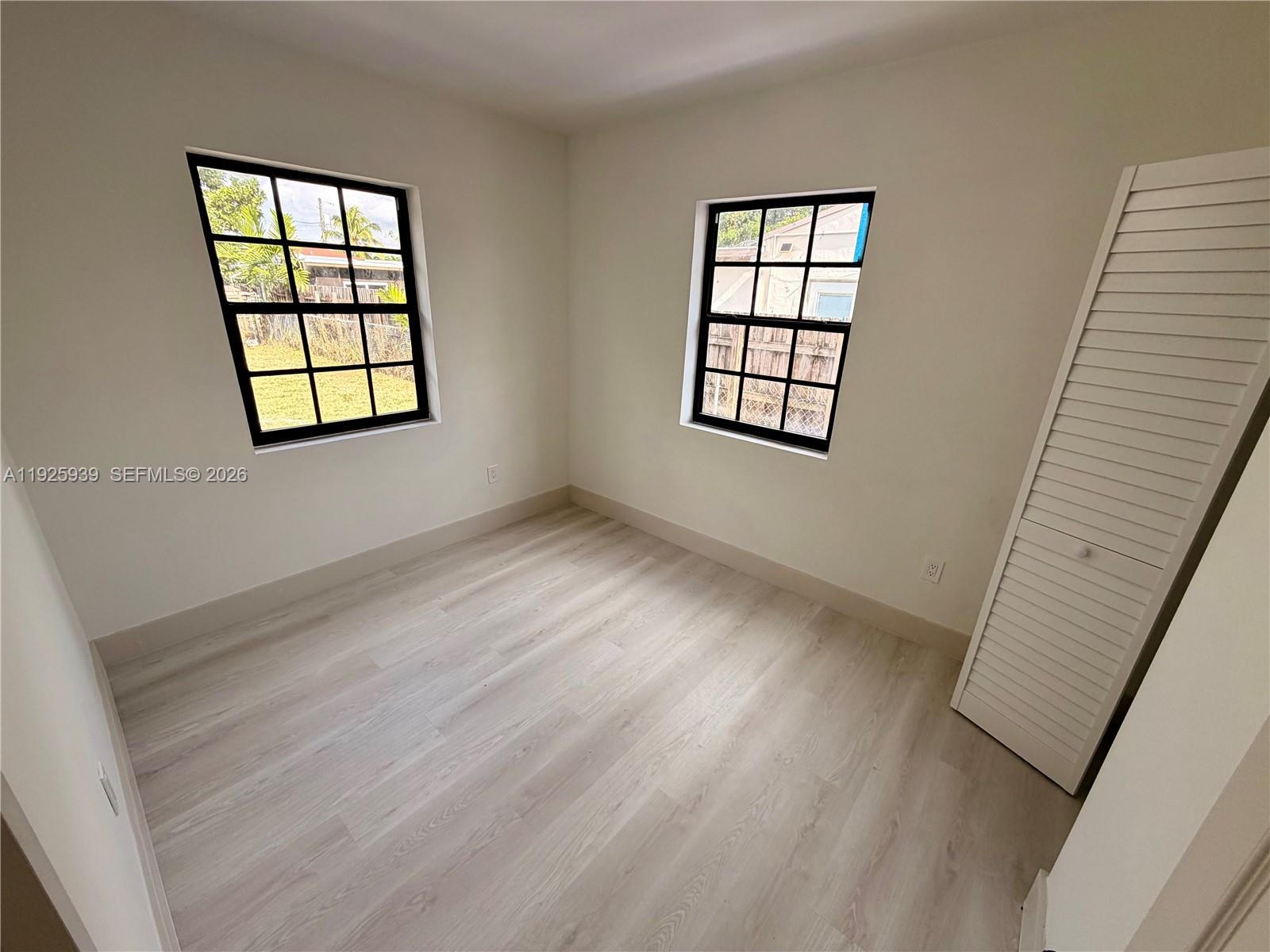 3527 Northwest 17th Street Miami, FL 33125 - Photo 10 of 16 an empty room with windows