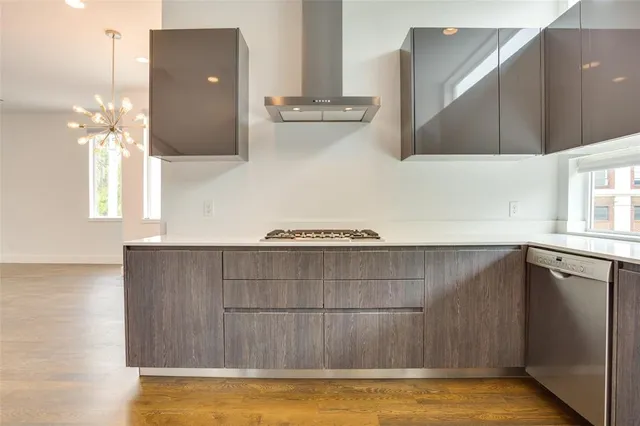 a view of a kitchen with furniture and wooden floor