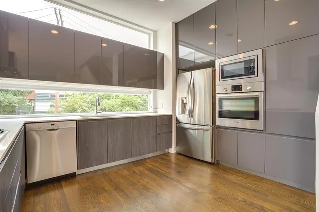 a kitchen with stainless steel appliances granite countertop a refrigerator and a microwave