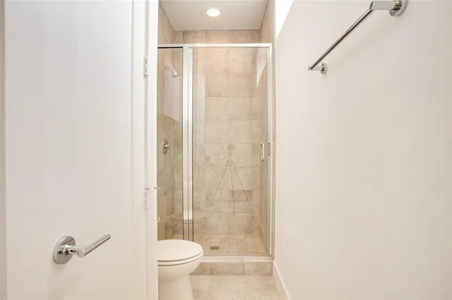 a bathroom with a shower and a toilet