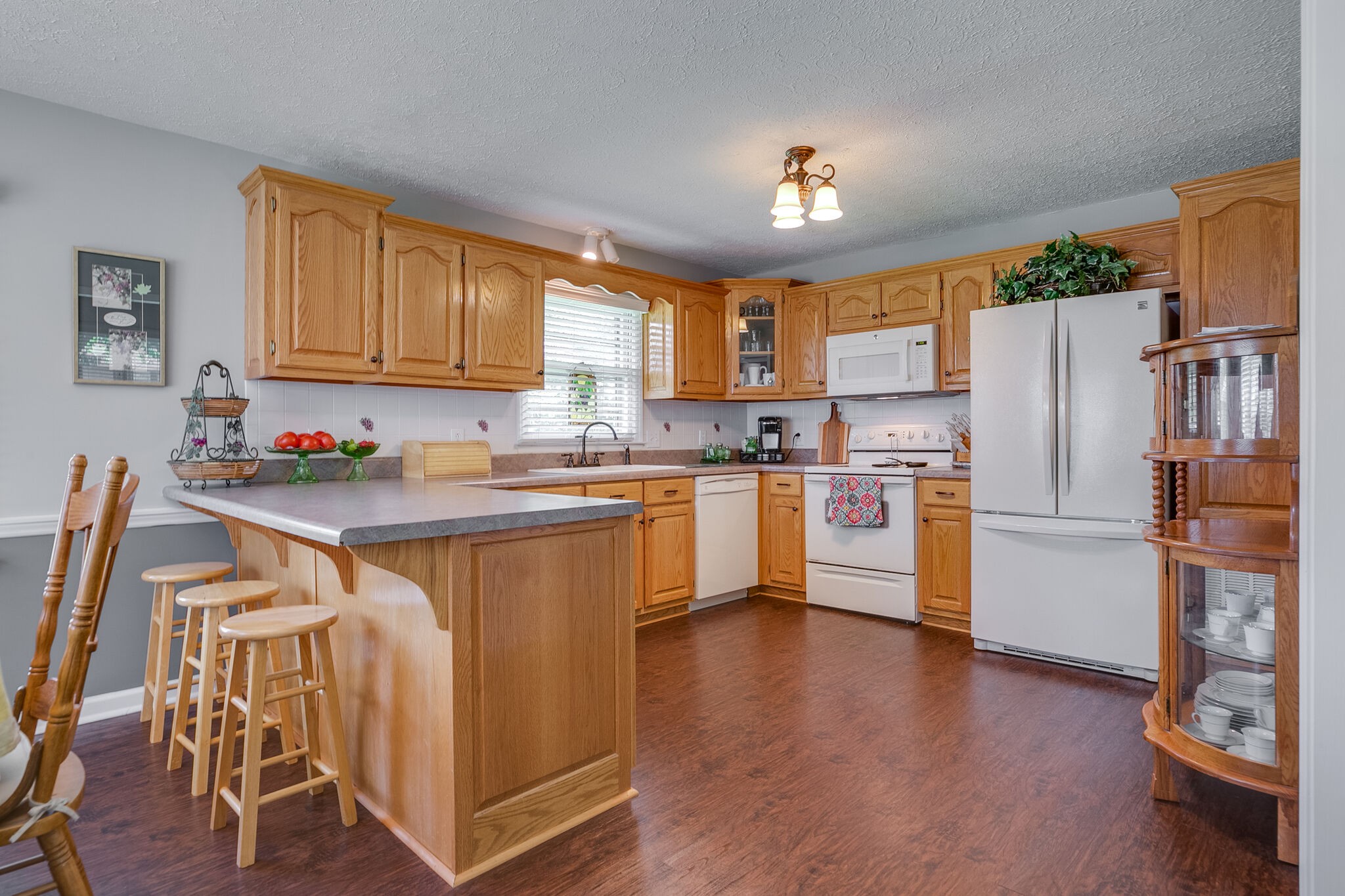 117 Paschal Drive Murfreesboro, TN 37128 - Photo 17 of 32 a kitchen with stainless steel appliances granite countertop a refrigerator a stove a sink dishwasher and white cabinets with wooden floor