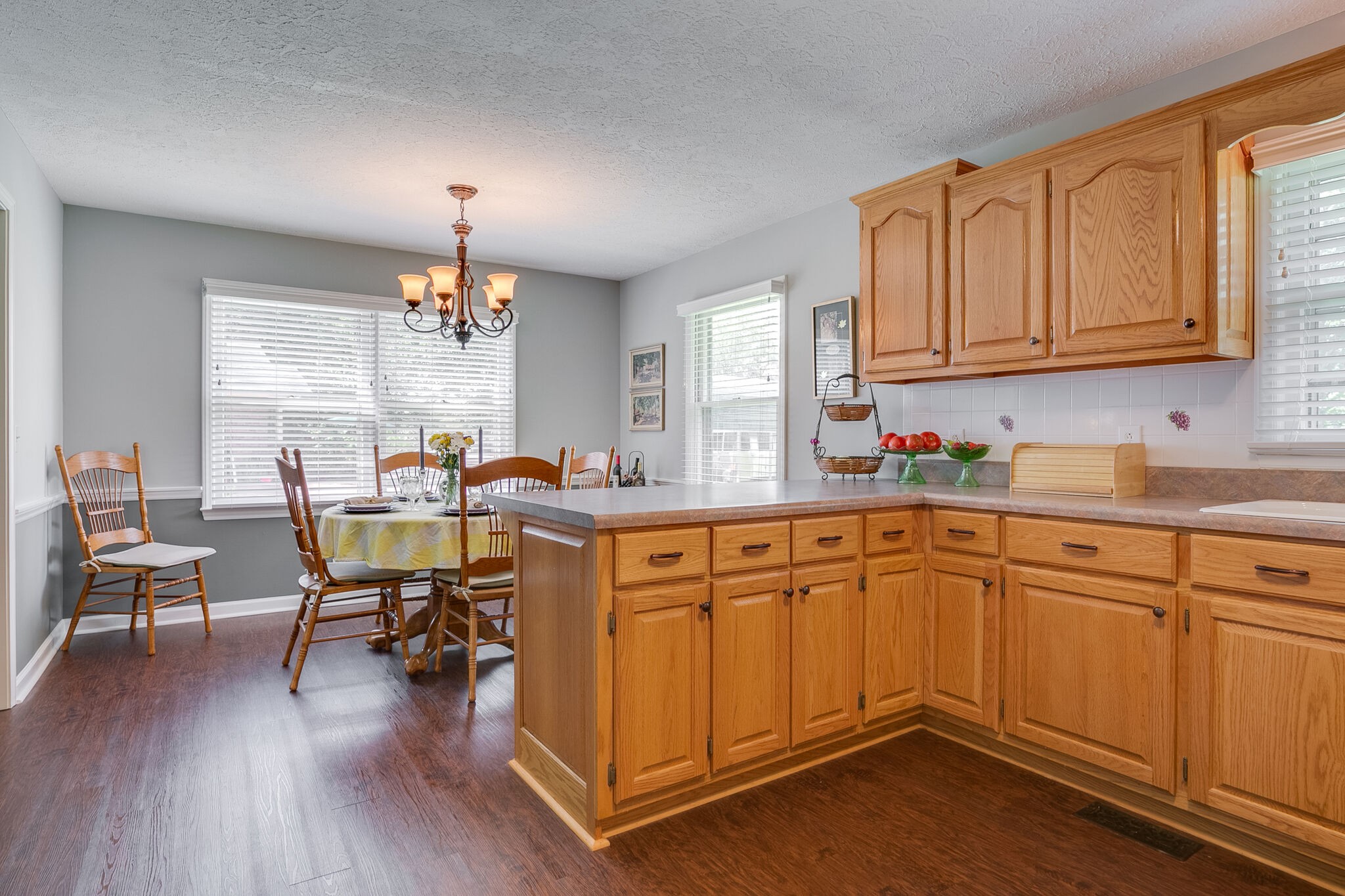 117 Paschal Drive Murfreesboro, TN 37128 - Photo 19 of 32 a kitchen with stainless steel appliances granite countertop wooden floors and white cabinets
