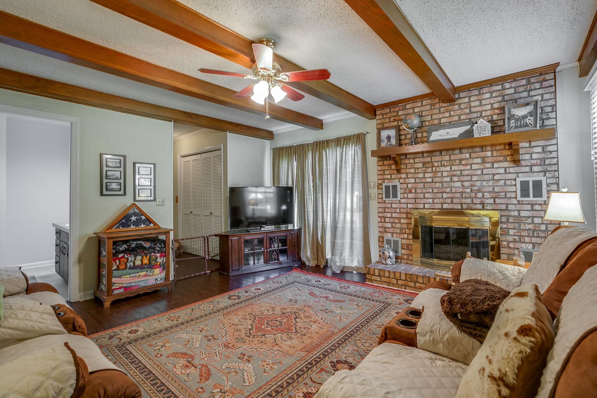 117 Paschal Drive Murfreesboro, TN 37128 - Photo 9 of 32 a living room with furniture a flat screen tv and a fireplace