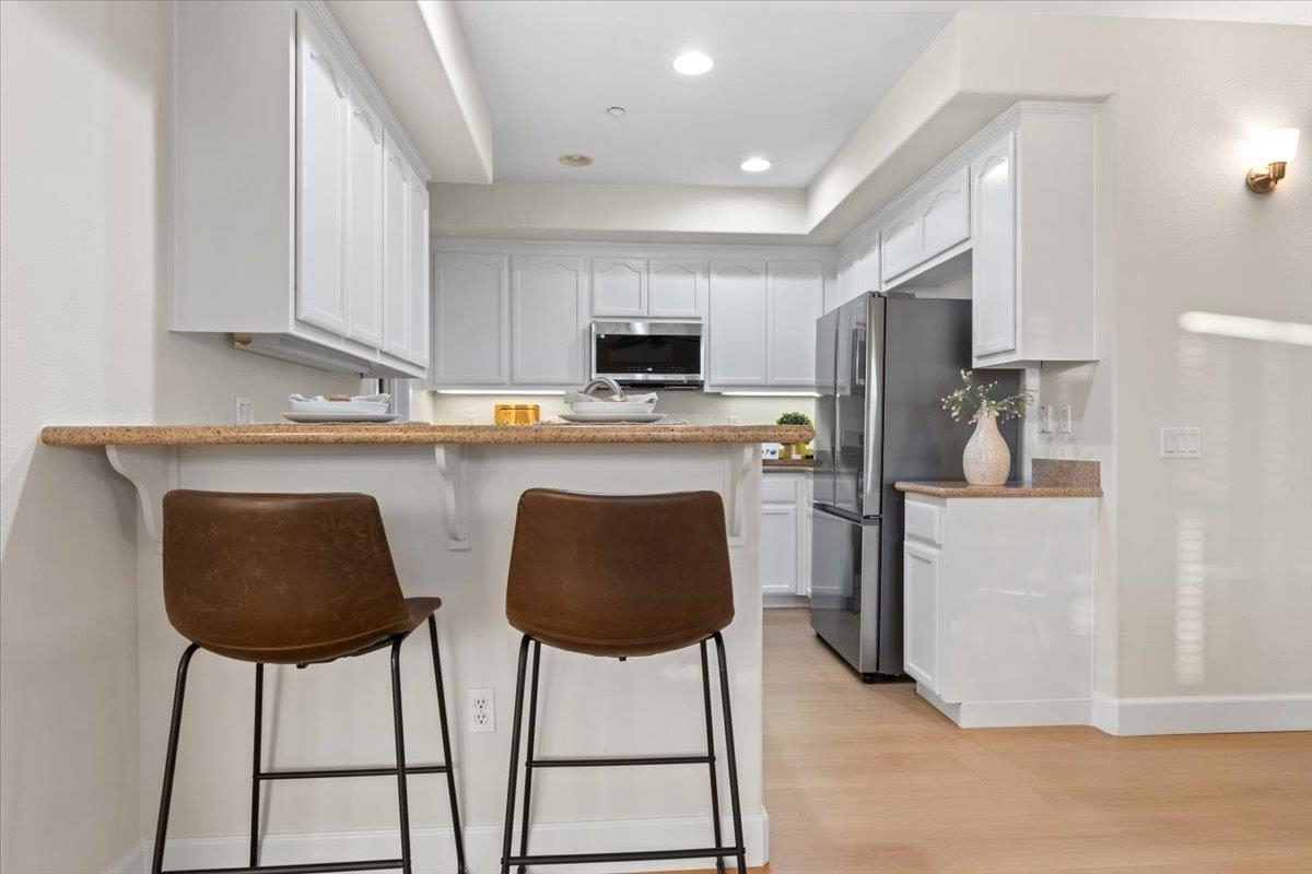 3251 Monaghan Street Dublin, CA 94568 - Photo 13 of 56 a kitchen with stainless steel appliances granite countertop a stove a sink and a refrigerator