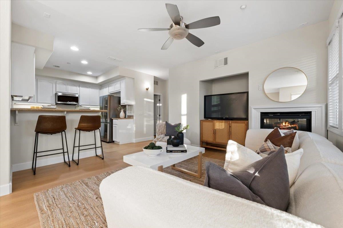 3251 Monaghan Street Dublin, CA 94568 - Photo 19 of 56 a living room with furniture a flat screen tv and kitchen view