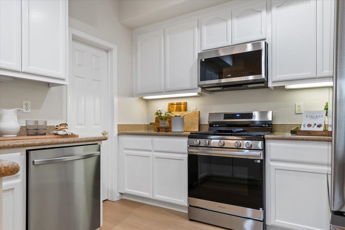 3251 Monaghan Street Dublin, CA 94568 - Photo 25 of 56 a kitchen with stainless steel appliances granite countertop a sink a stove top oven and cabinets