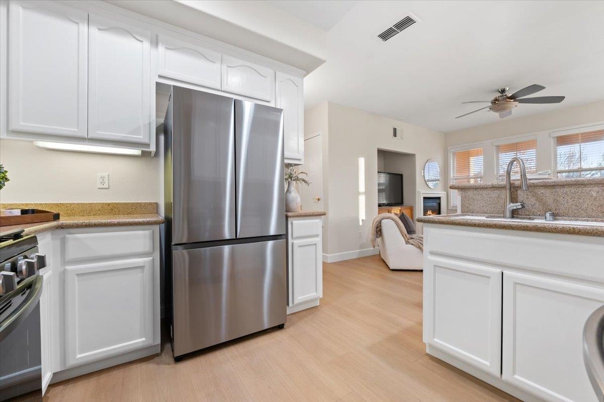 3251 Monaghan Street Dublin, CA 94568 - Photo 27 of 56 a kitchen with stainless steel appliances a refrigerator sink and cabinets