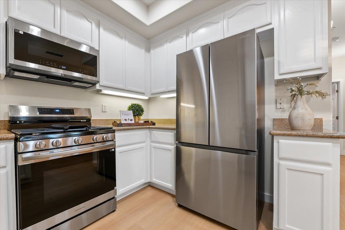 3251 Monaghan Street Dublin, CA 94568 - Photo 28 of 56 a kitchen with stainless steel appliances a refrigerator stove and microwave