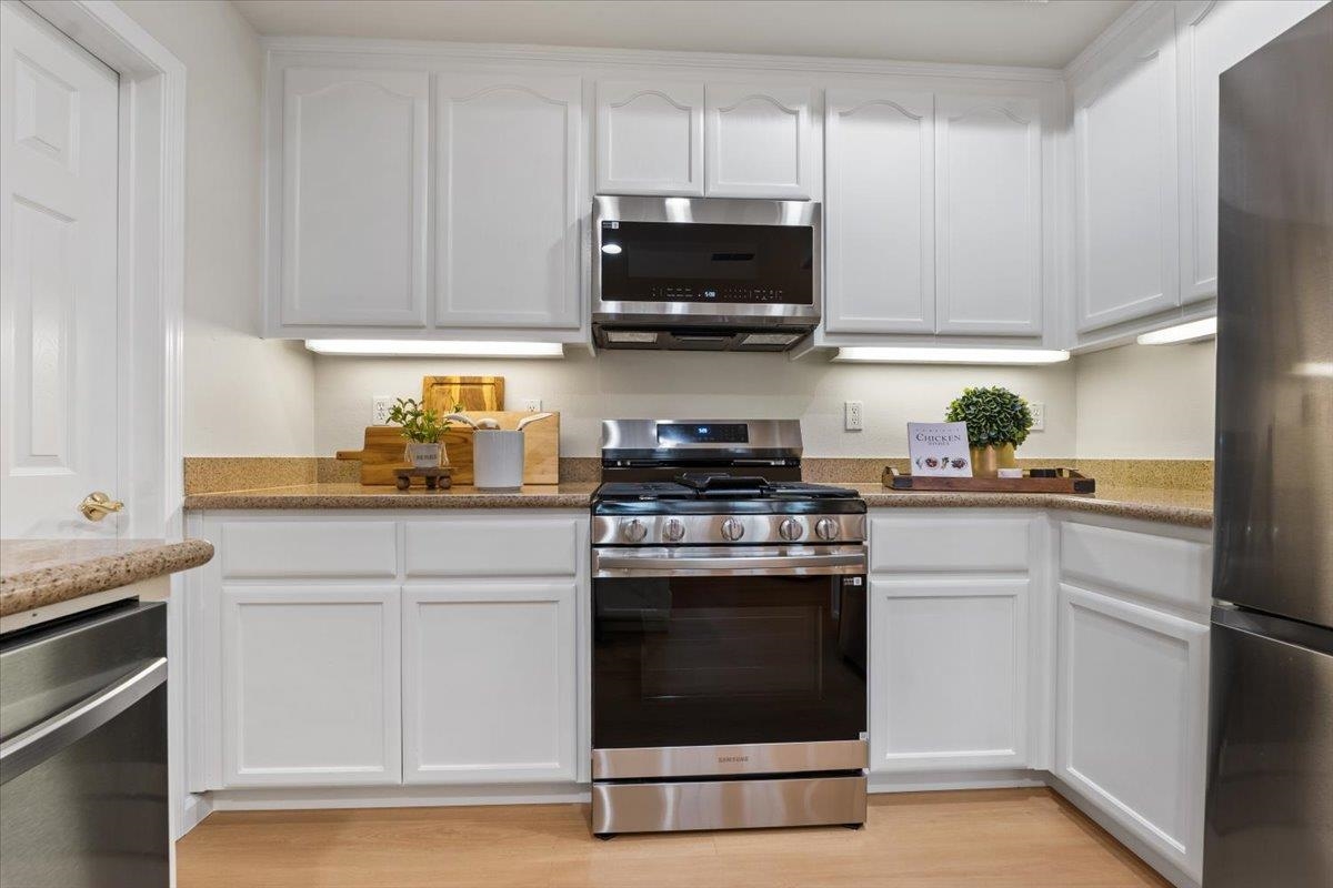 3251 Monaghan Street Dublin, CA 94568 - Photo 29 of 56 a kitchen with white cabinets stainless steel appliances and sink