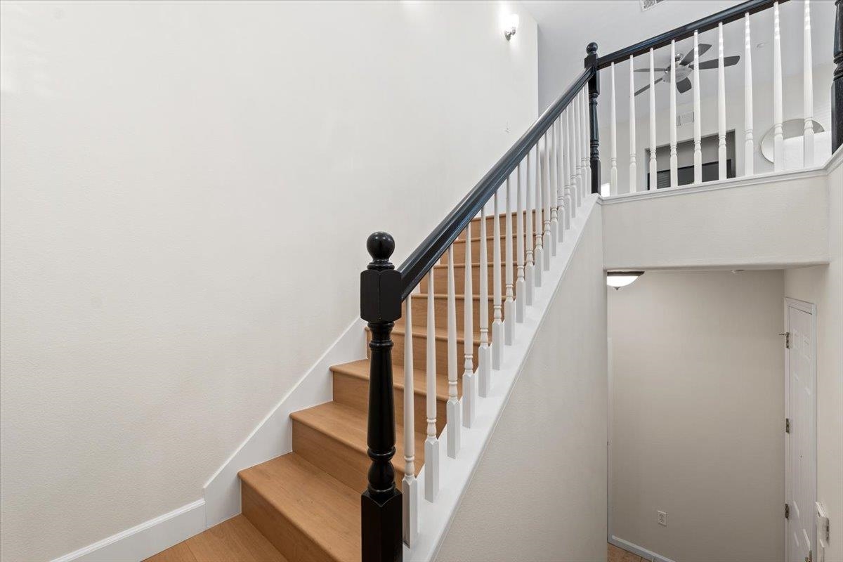 3251 Monaghan Street Dublin, CA 94568 - Photo 6 of 56 a view of staircase with lots of frames on wall and wooden floor