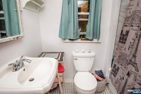 a bathroom with a toilet sink and mirror