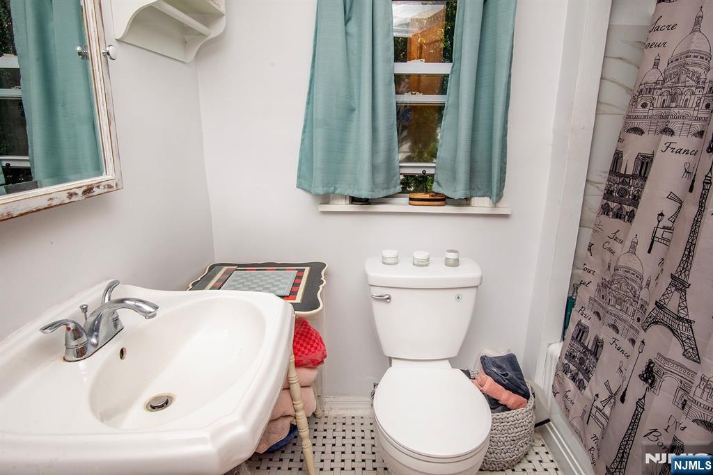 847 Red Road Teaneck, NJ 07666 - Photo 14 of 20 a bathroom with a toilet sink and mirror