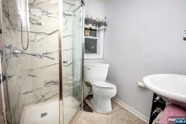 a bathroom with a toilet a sink and shower