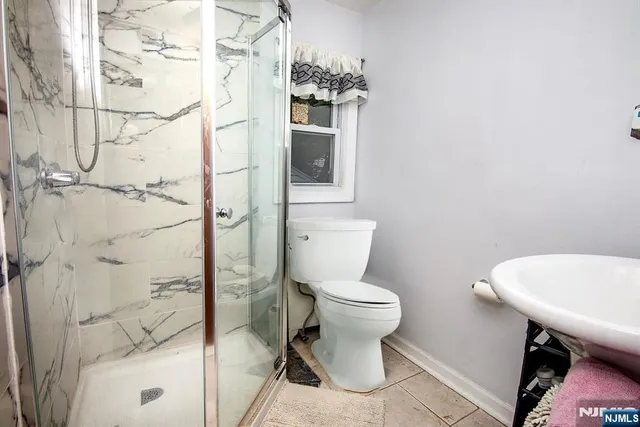 a bathroom with a toilet a sink and shower