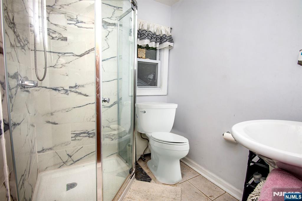 847 Red Road Teaneck, NJ 07666 - Photo 15 of 20 a bathroom with a toilet a sink and shower