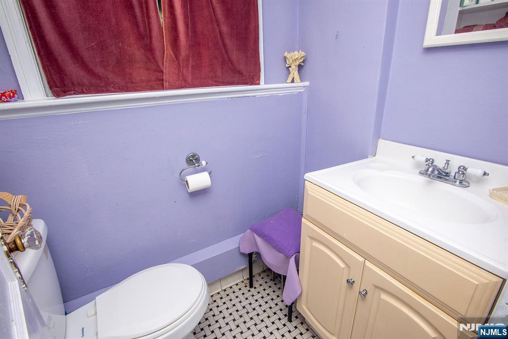 847 Red Road Teaneck, NJ 07666 - Photo 16 of 20 a bathroom with a sink a toilet and a window