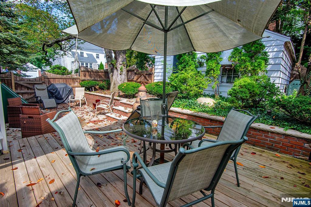 847 Red Road Teaneck, NJ 07666 - Photo 19 of 20 a view of an outdoor sitting area with furniture and umbrella